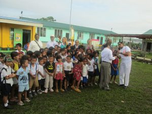 Children and volunteers in front of constructed San Isidro school